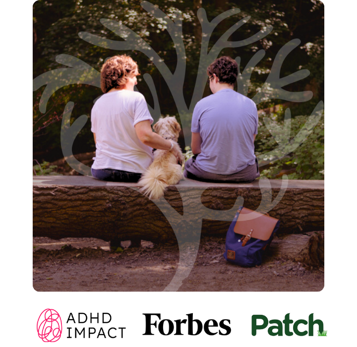 Parent and child sitting in a forest with backs facing the camera with text on screen saying Support for parents of children with ADHD/Autism